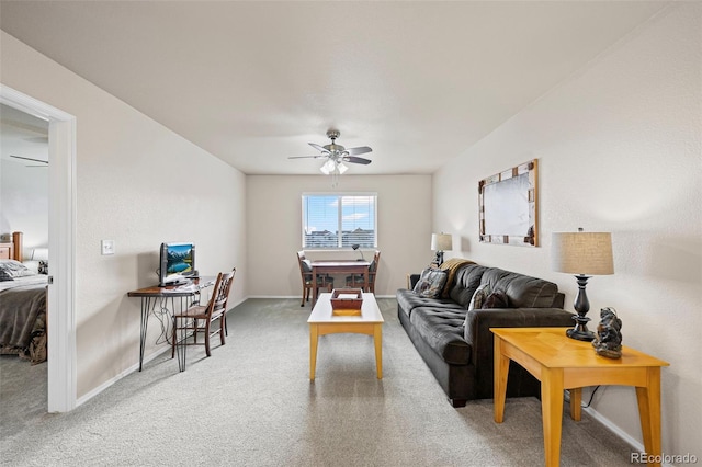 carpeted living room featuring ceiling fan