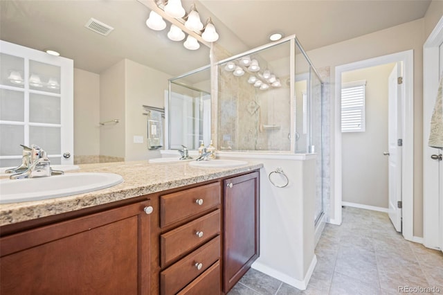 bathroom with tile patterned floors, vanity, and a shower with shower door