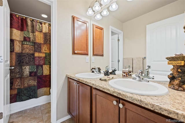 bathroom with a shower with curtain, tile patterned floors, and vanity