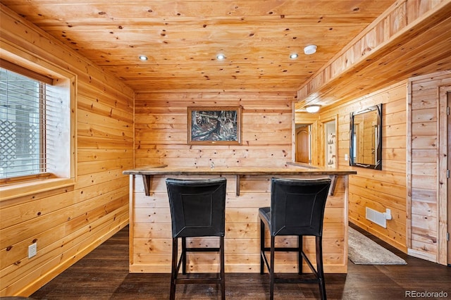 bar with wooden ceiling, dark hardwood / wood-style floors, and wood walls