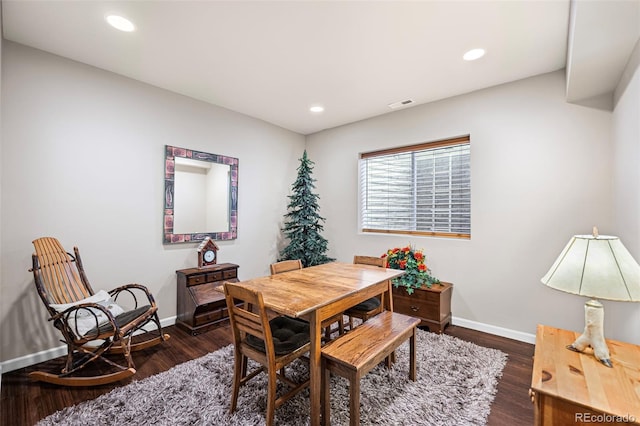 dining area with dark hardwood / wood-style floors