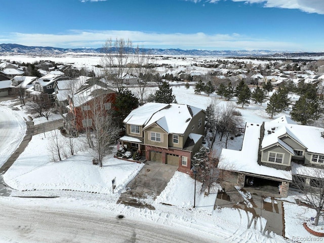 snowy aerial view featuring a mountain view