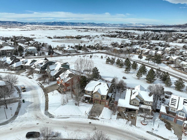 snowy aerial view featuring a mountain view