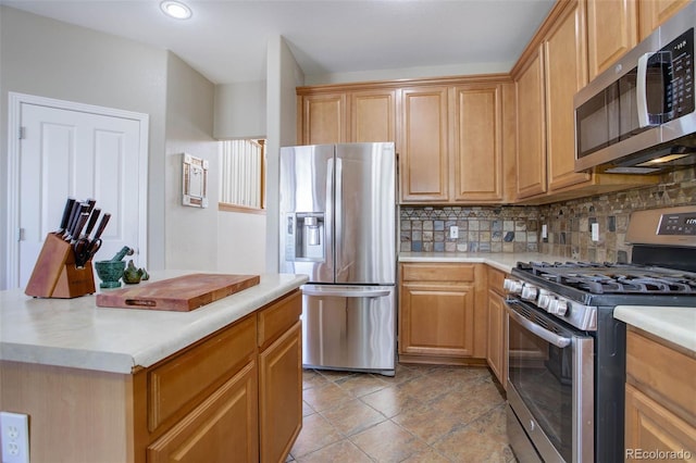 kitchen featuring stainless steel appliances and tasteful backsplash