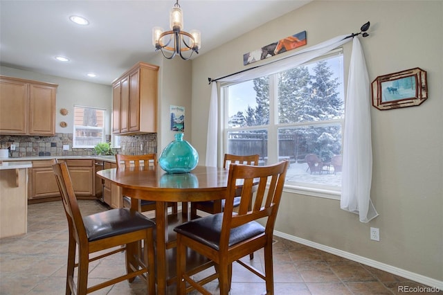 dining area with an inviting chandelier