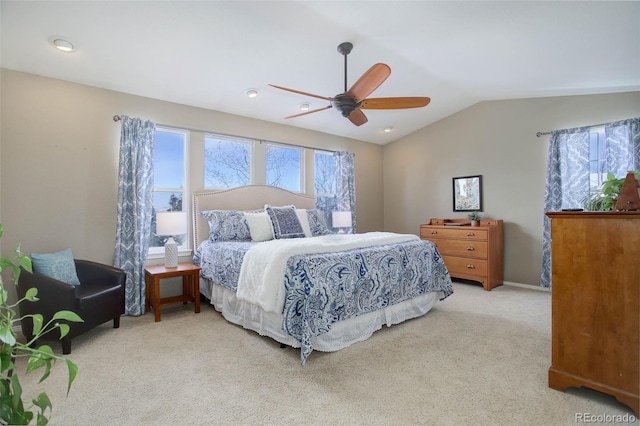 bedroom with light colored carpet, vaulted ceiling, and ceiling fan