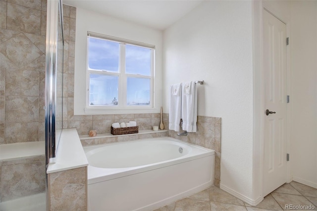 bathroom with shower with separate bathtub and tile patterned floors