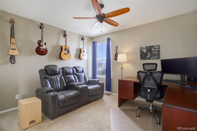 carpeted home office featuring ceiling fan