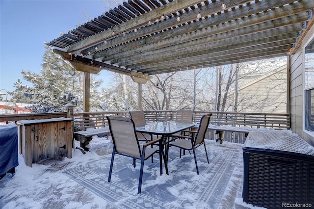 snow covered deck with a pergola