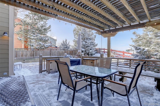 snow covered patio featuring a pergola