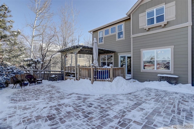 view of snow covered rear of property