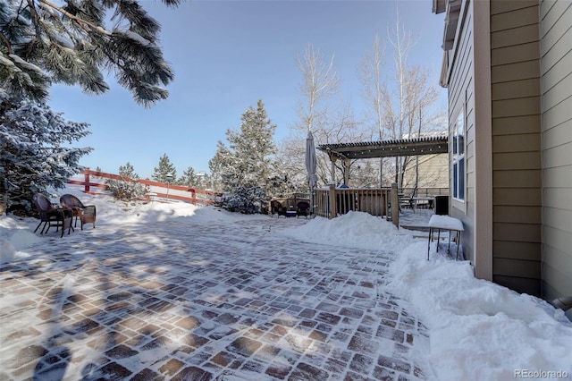 yard layered in snow featuring a pergola