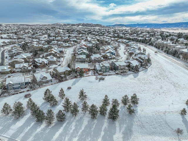 snowy aerial view featuring a mountain view