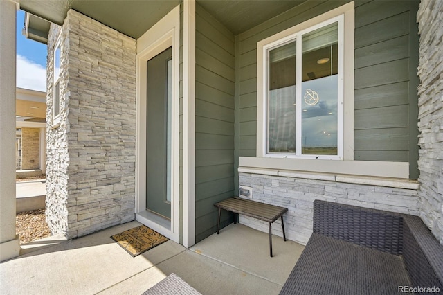 doorway to property with stone siding