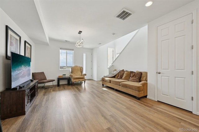 living area featuring light wood finished floors, stairs, recessed lighting, baseboards, and visible vents