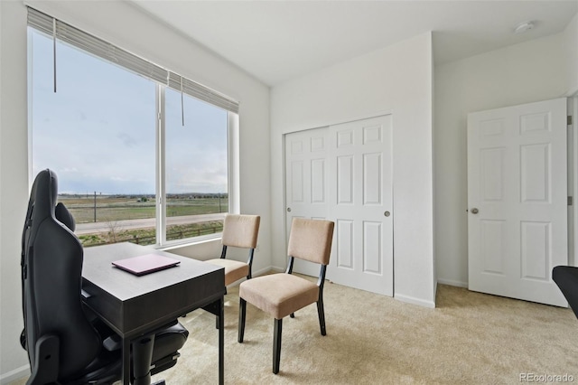 carpeted office space featuring baseboards