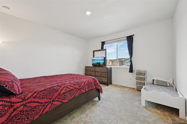 bedroom featuring carpet floors and baseboards