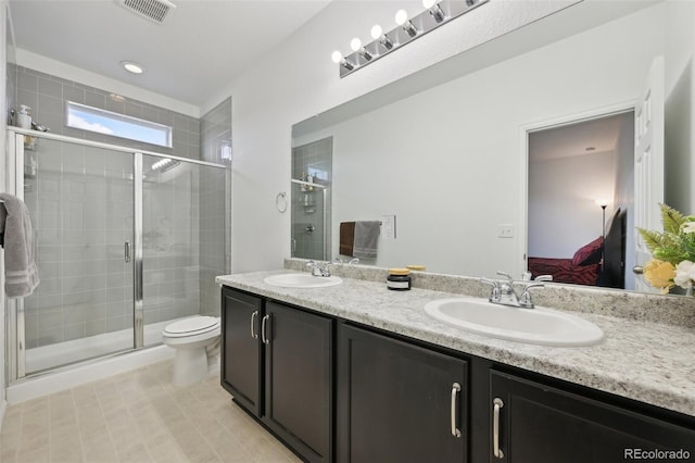 full bath with double vanity, a shower stall, a sink, and ensuite bath