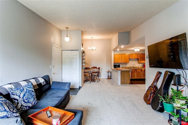 2280 S Oswego Way Unit 303, Aurora, CO 80014 - living area with carpet floors, a chandelier, and a textured ceiling
