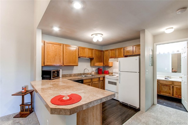 2280 S Oswego Way Unit 303, Aurora, CO 80014 - kitchen featuring white appliances, under cabinet range hood, light countertops, a peninsula, and a kitchen bar