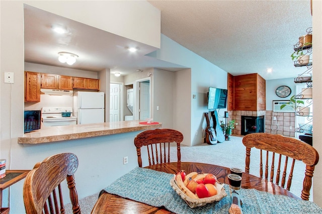 2280 S Oswego Way Unit 303, Aurora, CO 80014 - carpeted dining area with a fireplace, lofted ceiling, a textured ceiling, and recessed lighting