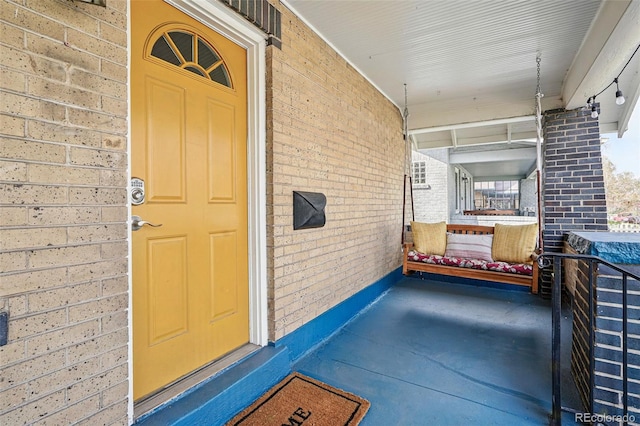property entrance featuring brick siding