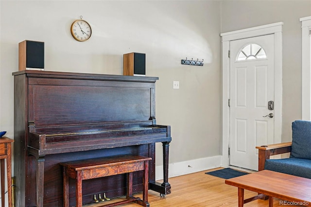 entrance foyer featuring baseboards and wood finished floors