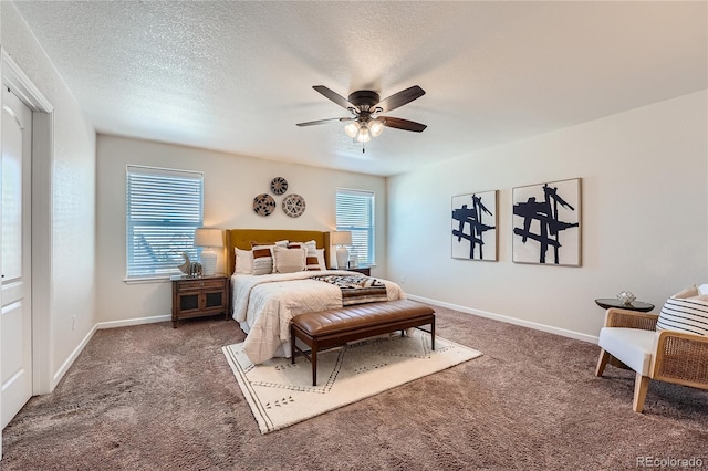 bedroom with dark colored carpet, ceiling fan, and a textured ceiling