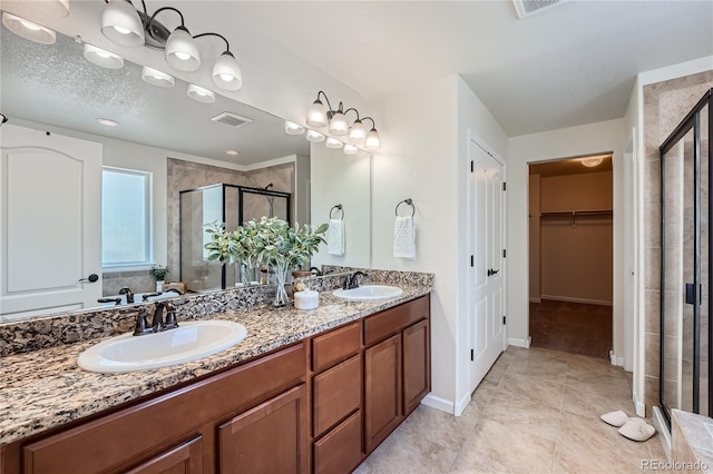 bathroom with vanity, tile patterned floors, and walk in shower