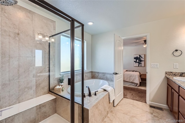 bathroom with vanity, tile patterned floors, ceiling fan, a textured ceiling, and independent shower and bath