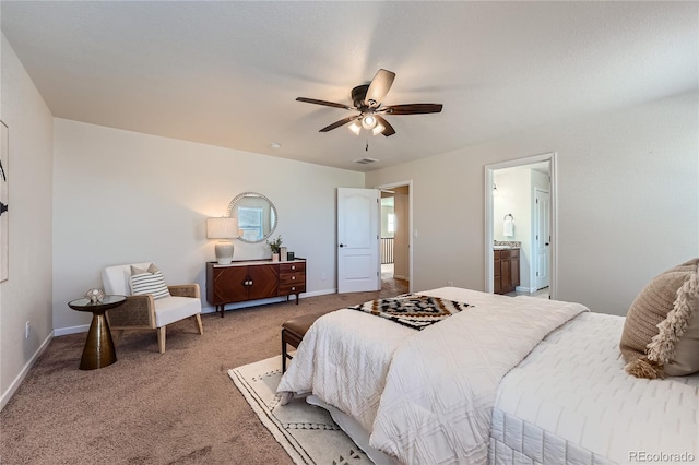 bedroom featuring a ceiling fan, visible vents, baseboards, carpet floors, and connected bathroom