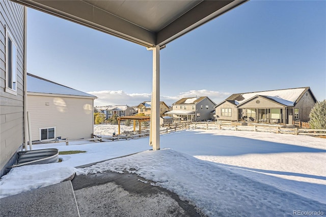 yard covered in snow with a residential view