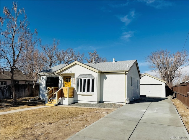 view of front of home featuring a garage and an outdoor structure