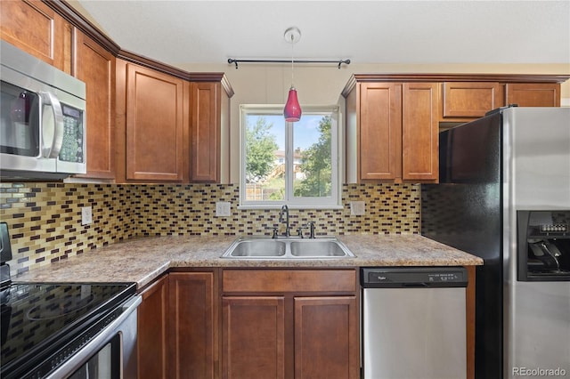 kitchen with appliances with stainless steel finishes, sink, and backsplash