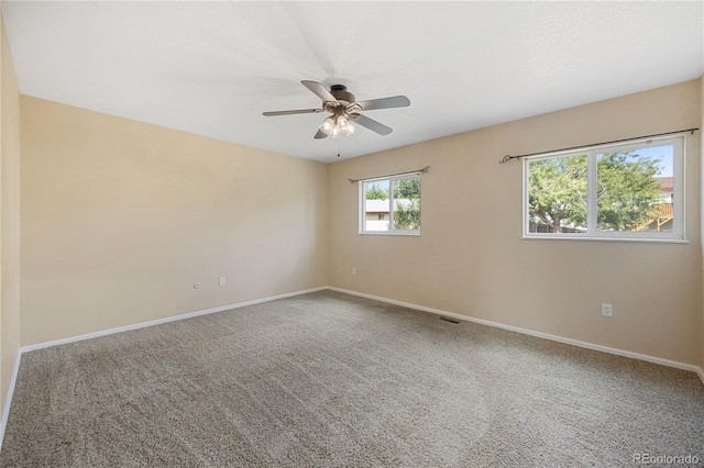 carpeted empty room with ceiling fan