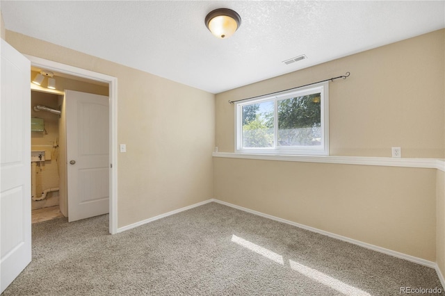 spare room featuring carpet flooring