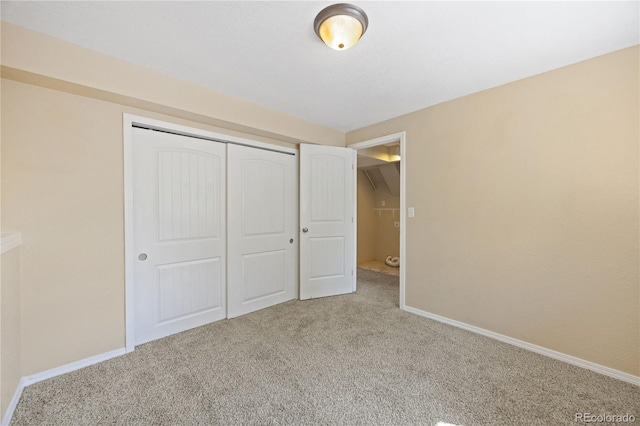 unfurnished bedroom featuring a closet and carpet flooring