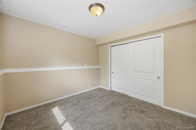 unfurnished bedroom featuring a closet and carpet flooring