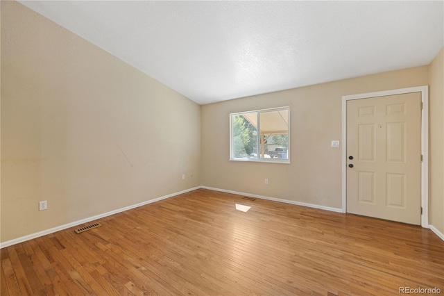 spare room with light hardwood / wood-style floors