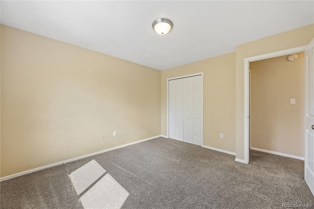 unfurnished bedroom with a closet and carpet flooring