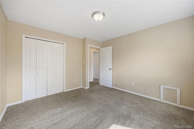 unfurnished bedroom featuring carpet floors and a closet