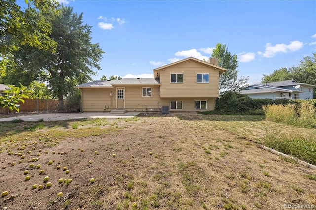 rear view of property featuring central air condition unit and a patio area