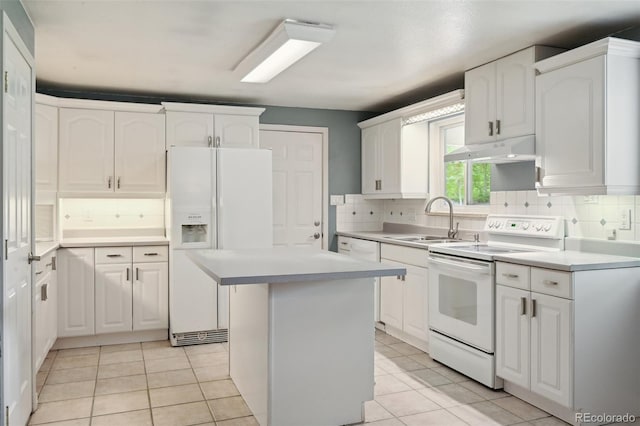3784 Swadley St, Wheat Ridge, CO 80033 - kitchen with white appliances, under cabinet range hood, white cabinetry, a center island, and backsplash