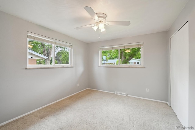 3784 Swadley St, Wheat Ridge, CO 80033 - unfurnished bedroom featuring multiple windows, carpet flooring, and a closet