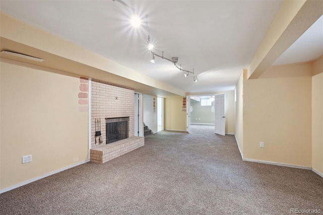 3784 Swadley St, Wheat Ridge, CO 80033 - unfurnished living room featuring carpet floors, track lighting, and a brick fireplace