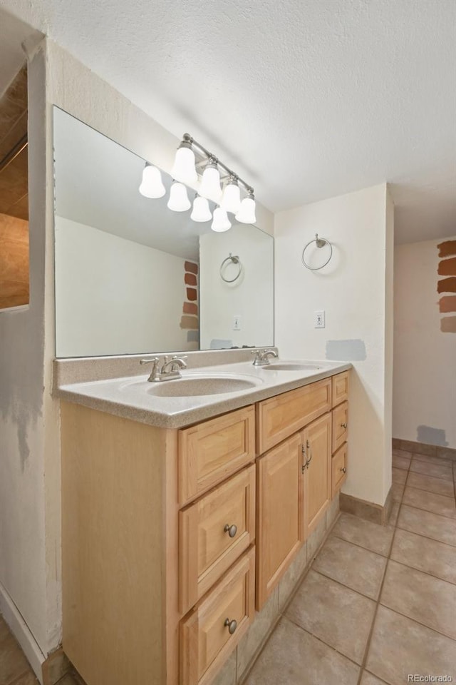 3784 Swadley St, Wheat Ridge, CO 80033 - bathroom featuring double vanity, tile patterned floors, and a textured ceiling