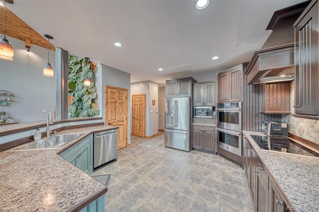 10757 Vista Farms Ct, Salida, CO 81201 - kitchen featuring appliances with stainless steel finishes, wall chimney range hood, recessed lighting, backsplash, and hanging light fixtures