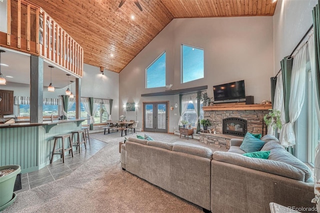 10757 Vista Farms Ct, Salida, CO 81201 - tiled living room with high vaulted ceiling, wooden ceiling, and a stone fireplace
