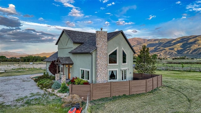 10757 Vista Farms Ct, Salida, CO 81201 - view of property exterior with stucco siding, a chimney, a mountain view, and a rural view