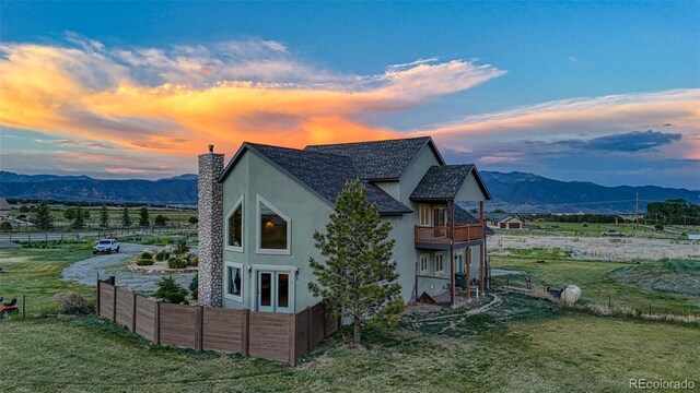10757 Vista Farms Ct, Salida, CO 81201 - view of side of home featuring a chimney, stucco siding, a mountain view, a balcony, and a view of countryside